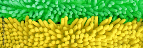 rag for cleaning .Microfiber texture with a soft large pile. Top view texture of green and yellow big microfiber fabric towel.Mitts for washing and drying car.cleaning supplies. Web banner