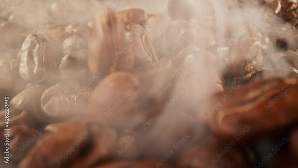 Super slow motion of coffee beans pile with camera move. Filmed on high speed cinema camera.