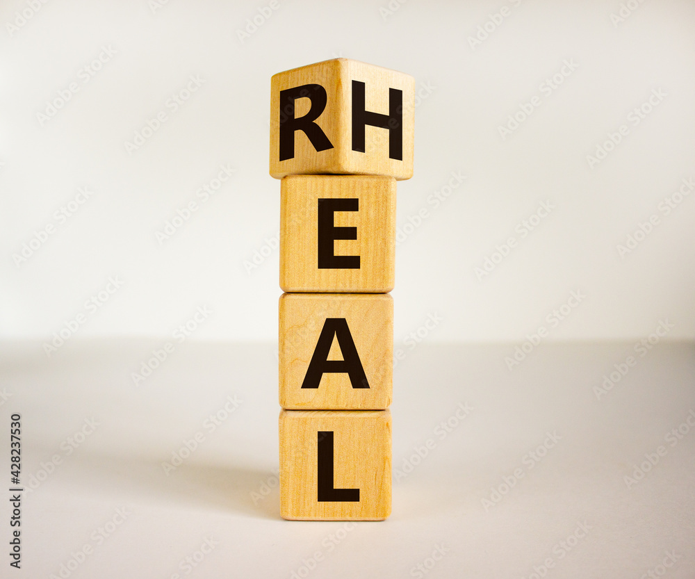Real heal symbol. Turned cubes with words 'Real heal'. Beautiful white background, copy space. Medical and real heal concept. Real heal symbol. Turned cubes with words 'Real heal'. Beautiful white background, copy space. Medical and real heal concept.