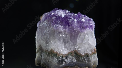 Amethyst Close Up.  Close up view of an Amethyst  rock rotating in the dark background.