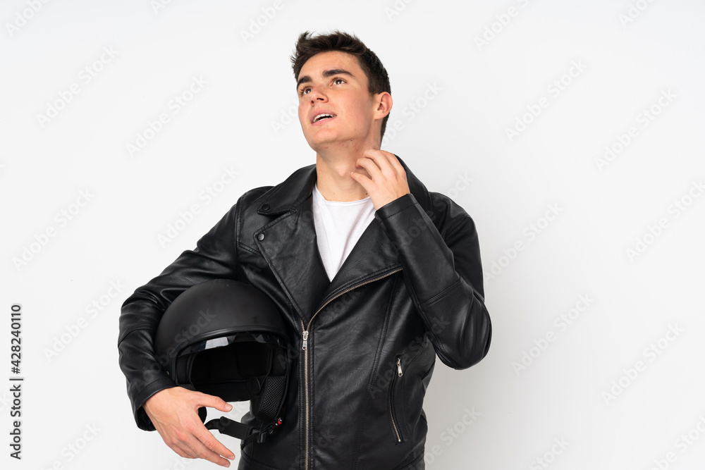 Man holding a motorcycle helmet isolated on white background thinking an idea Man holding a motorcycle helmet isolated on white background thinking an idea