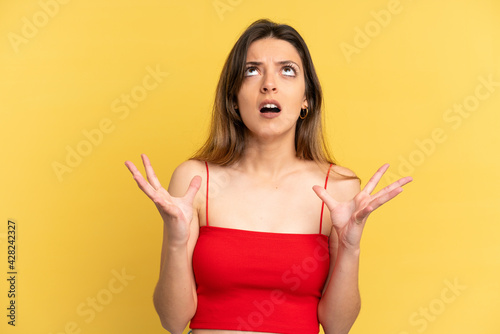 Young caucasian woman isolated on yellow background stressed overwhelmed © luismolinero