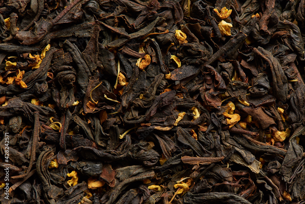 Tea leaves with flower petals as a background. Tea leaves with flower petals as a background.