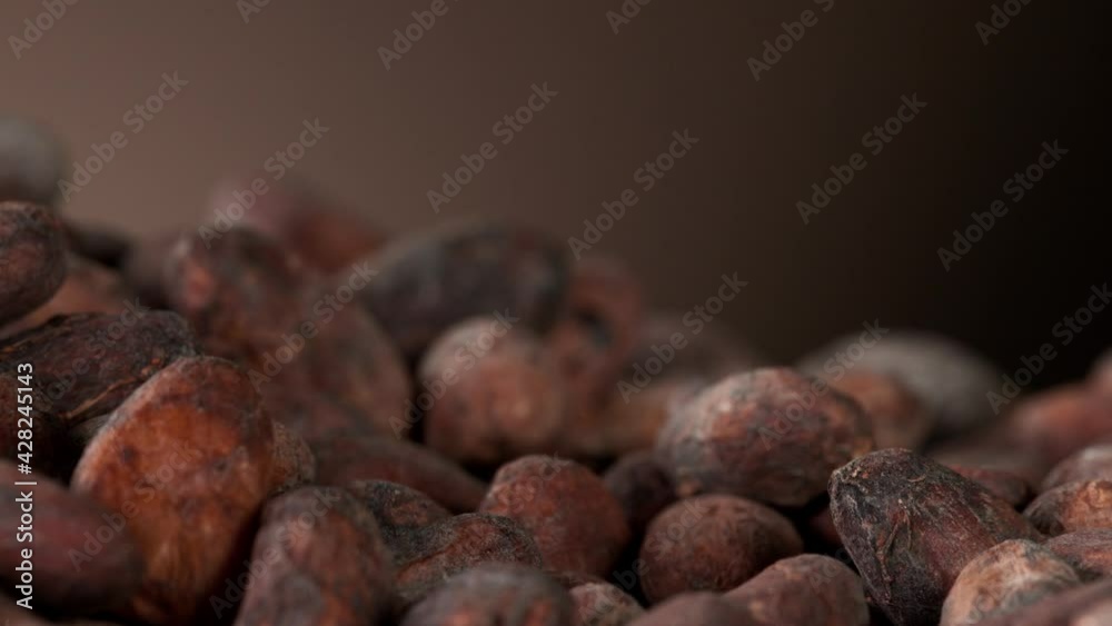 Super slow motion of falling group of roasted cocoa beans pieces. Filmed on high speed cinema camera, 1000fps. Super slow motion of falling group of roasted cocoa beans pieces. Filmed on high speed cinema camera, 1000fps.