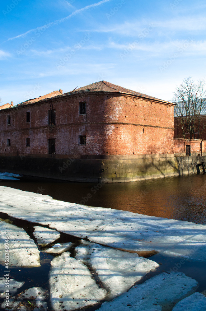 ruined red brick barracks, on the river bank