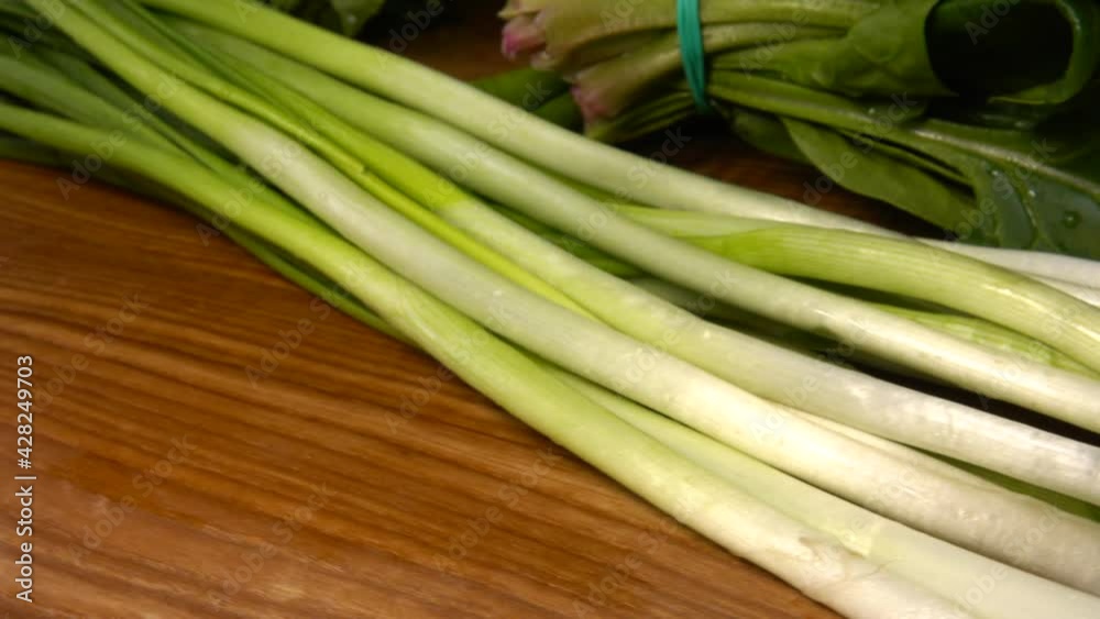 Spinach, fennel, parsley and green onions leaves on a wooden cutting board. Spinach, fennel, parsley and green onions leaves on a wooden cutting board.