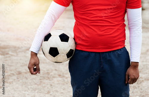 man holding a football with his arm © VVargas