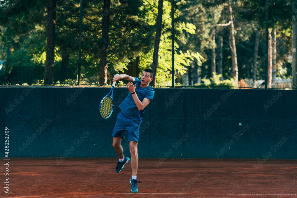 A professional tennis player is serving ball on a clay tennis court