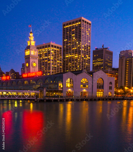 City  of San Francisco skyline at night with lights reflected in San Francisco Bay. © David