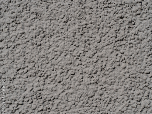 light grey rough grunge plaster with grain textured background