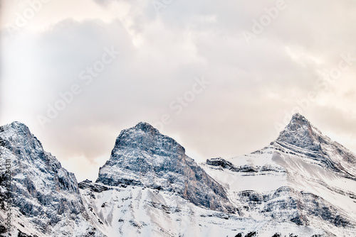 Fototapeta Naklejka Na Ścianę i Meble -  The snow topped Three Sisters and mountains surrounding Canmore Alberta at sunset