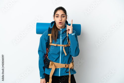 Young mountaineer man with a big backpack over isolated background intending to realizes the solution while lifting a finger up