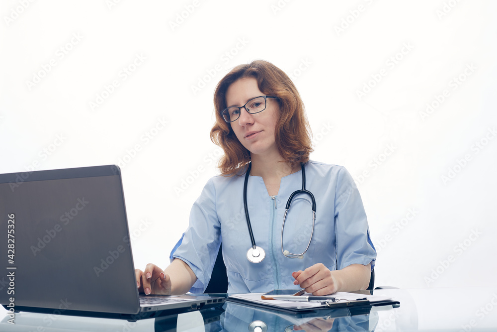 The doctor works at the laptop in the hospital. The doctor works at the laptop in the hospital.