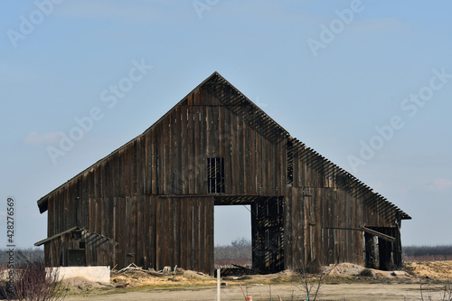 Landscape shot of an abandoned wooden farm