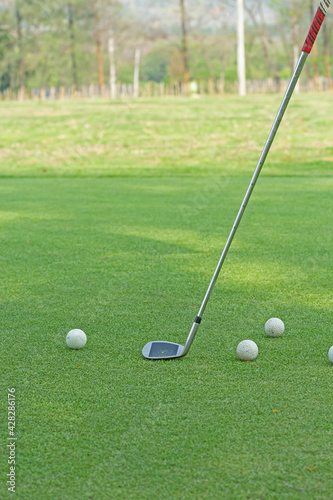 Golf clubs on green grass