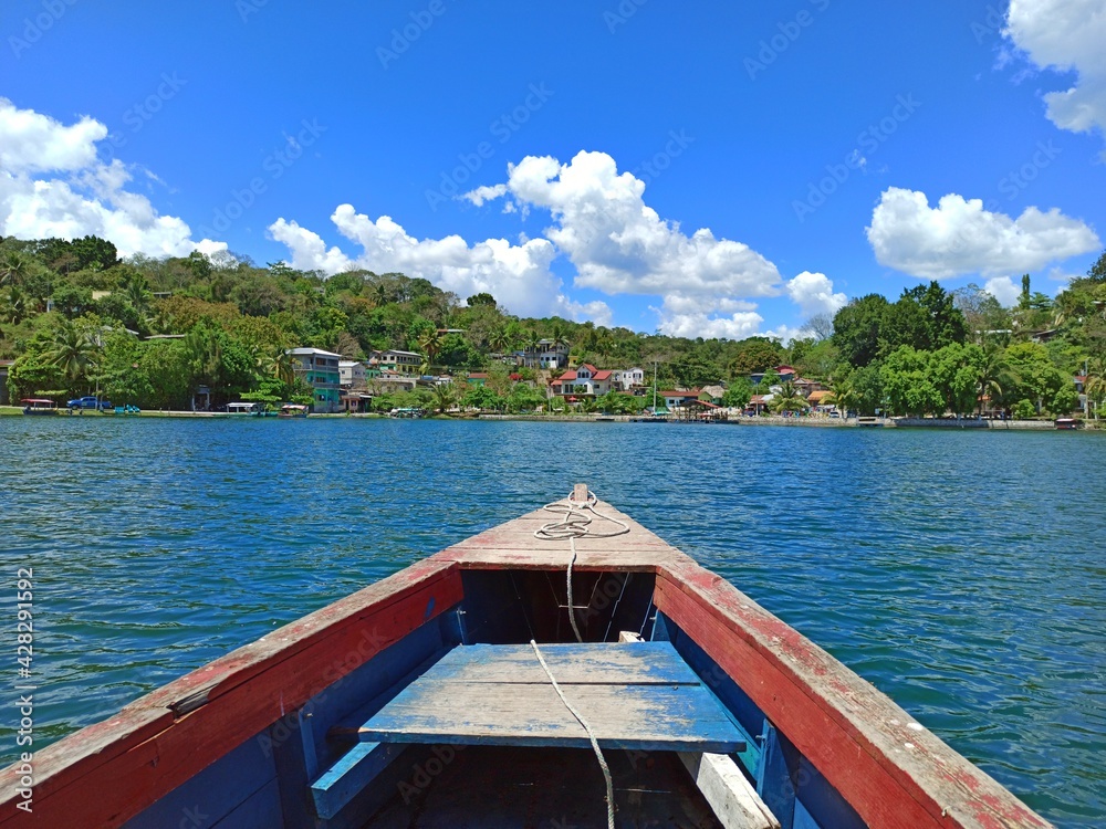 View from a boat on Lake Peten Itza with San Miguel in the background on a sunny day, Flores, Peten, Guatemala. Vacation concept