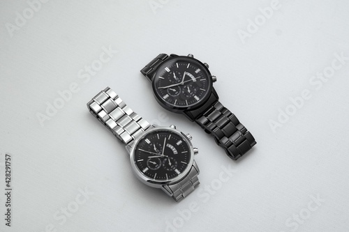 Luxury black and silver watch on white table. Monochromatic concept. Complementary color concept.