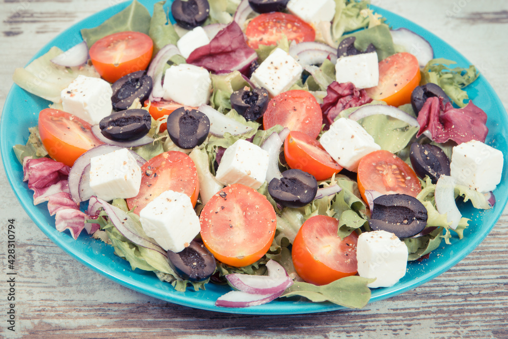 Fresh greek salad with feta cheese and vegetables as healthy meal containing vitamins and minerals