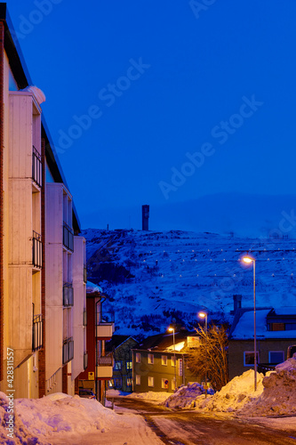 Kiruna, Sweden,  A Kiruna residential street and house at night and view towards the iron ore mine. © Alexander