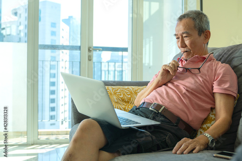 Photography Technology concept, senior citizen using laptop at home