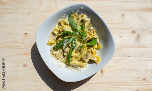 Casoncelli is a kind of ravioli, home made traditional food of the Bergamo area, Italy. Delicious Italian food. Simple food with ancient traditions. Casoncelli cooked served with parmesan cheese photo