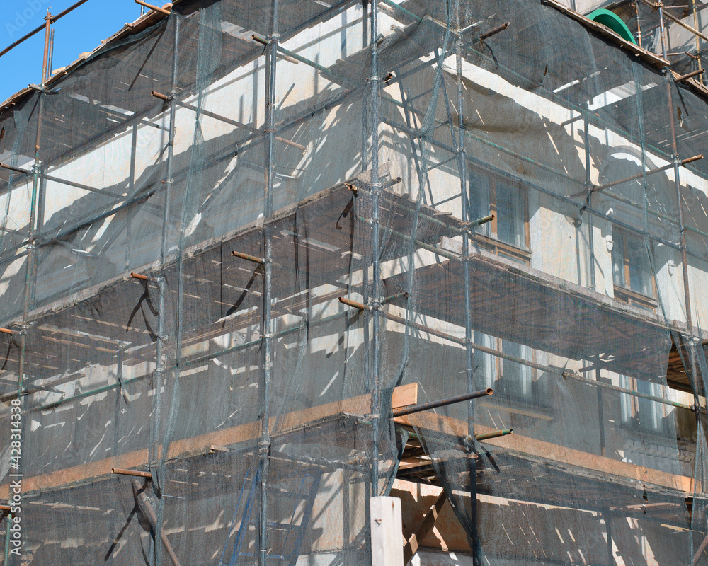 Fototapeta premium Construction work, reconstruction of an old building, restoration of the facade