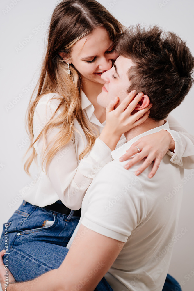 love, passionate and beautiful couple kisses, have fun against the white wall. love, passionate and beautiful couple kisses, have fun against the white wall.