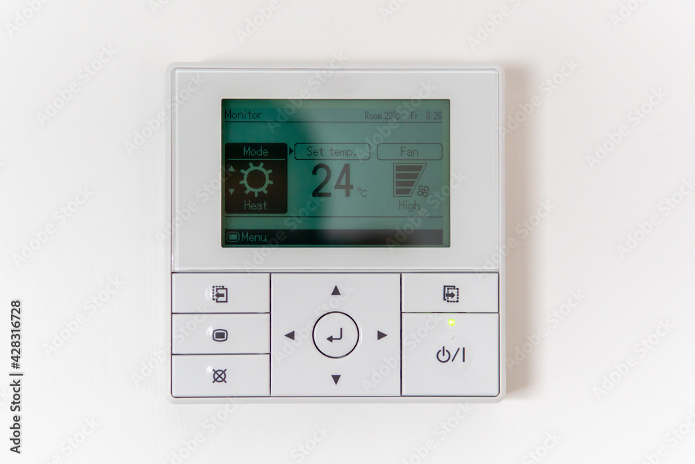 Air conditioning controller on the wall that shows an air temperature of 24 degrees Celsius Air conditioning controller on the wall that shows an air temperature of 24 degrees Celsius