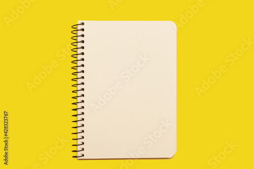 opened spiral notebook on a yellow surface