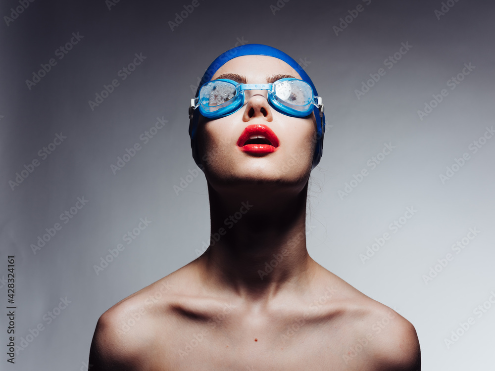 sportswoman with red lips in blue swimming cap and glasses looking up cropped view sportswoman with red lips in blue swimming cap and glasses looking up cropped view