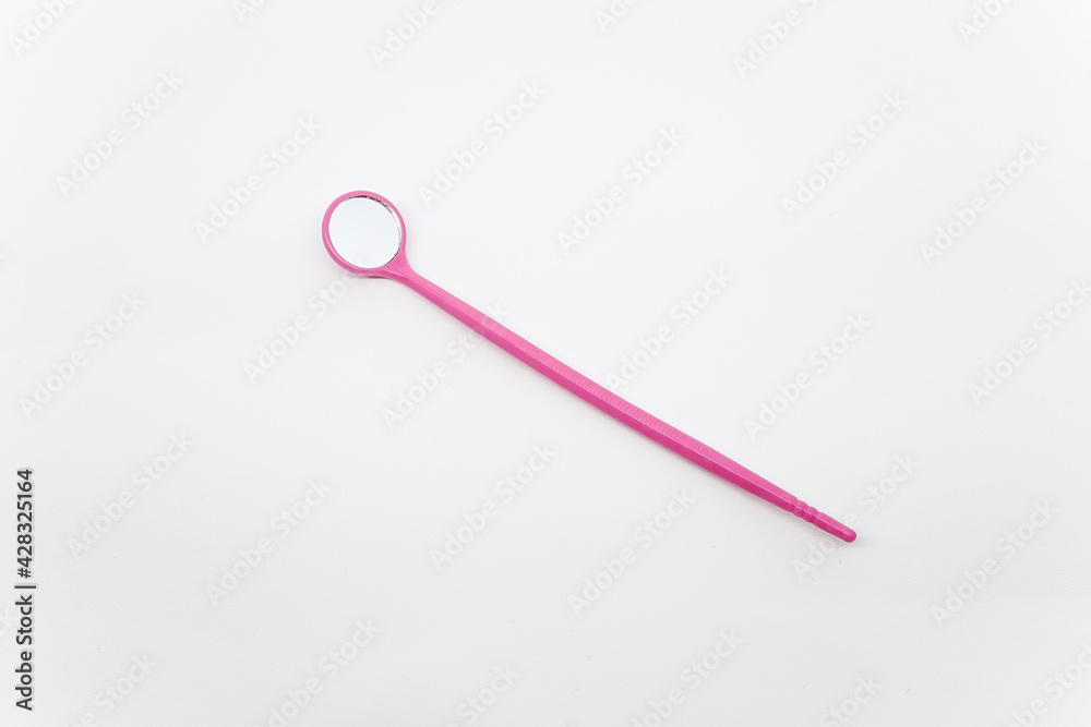 Mini pink eyelash extension mirror made of plastic on top of a white background. Mini pink eyelash extension mirror made of plastic on top of a white background.