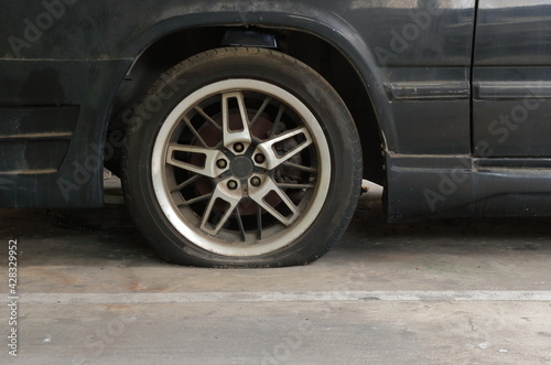 Closeup flat tire of abandoned car in parking lot © evergreentree