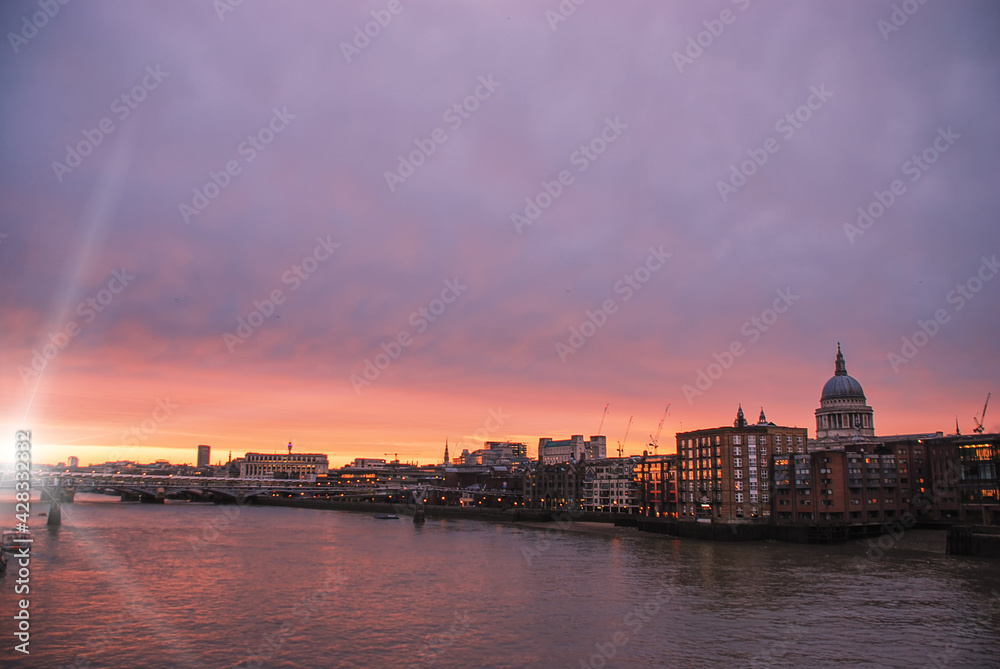 The iconic dome of St Pauls Cathedral on the London skyline at sunset