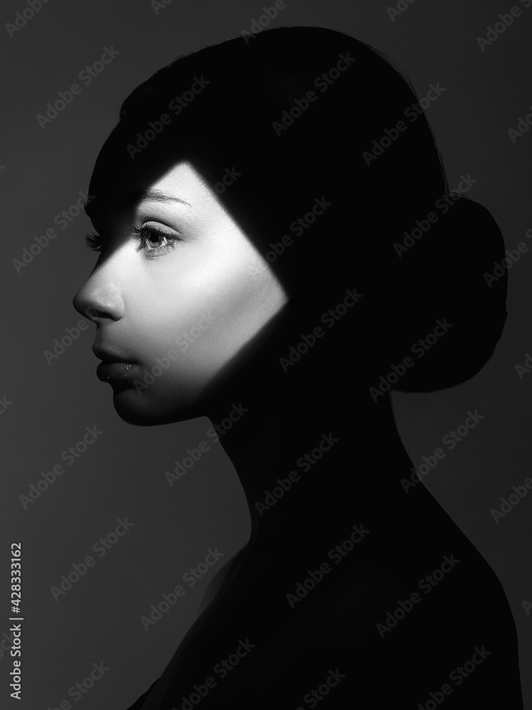 portrait of young woman in shadow portrait of young woman in shadow
