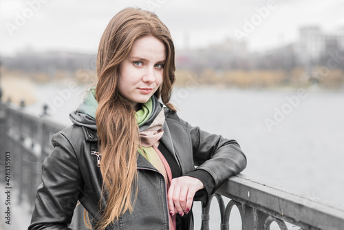 Portrait of a young girl who poses while walking in cloudy weather © Павел Костенко