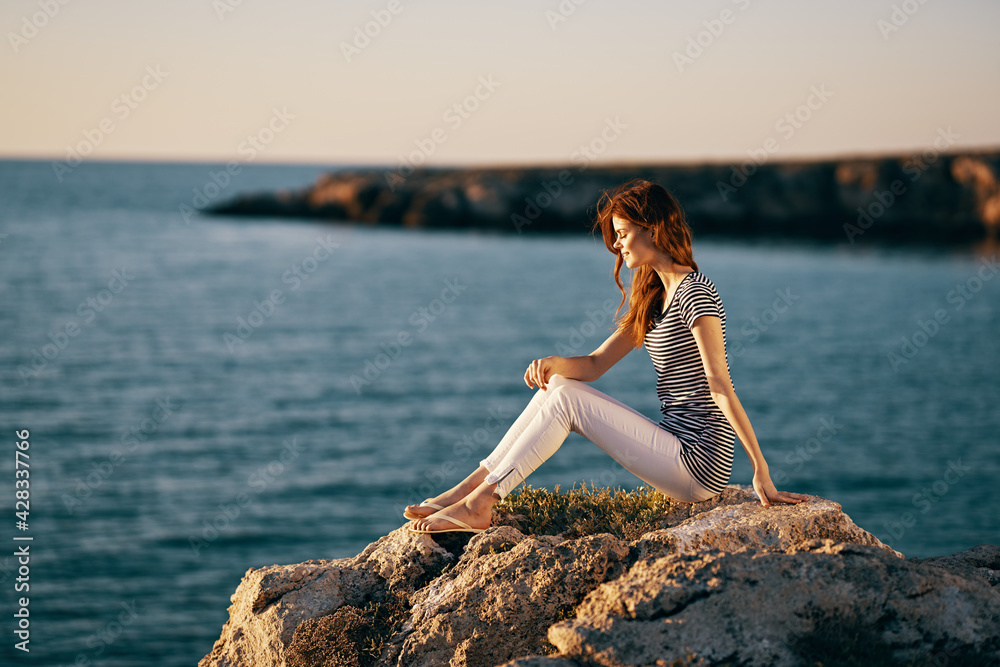 woman near the sea mountain on a large stone sea landscape sunset woman near the sea mountain on a large stone sea landscape sunset