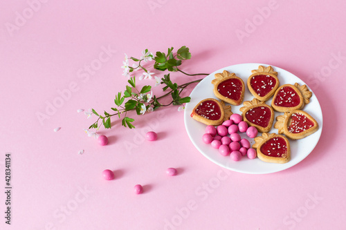 pink candy and cookies on a pink background