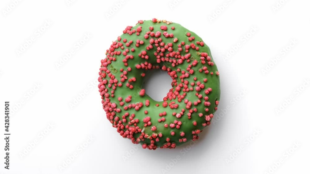 Closeup sweet delicious donut with green glaze and pink pastry topping. Shot with RED camera in 4K Closeup sweet delicious donut with green glaze and pink pastry topping. Shot with RED camera in 4K