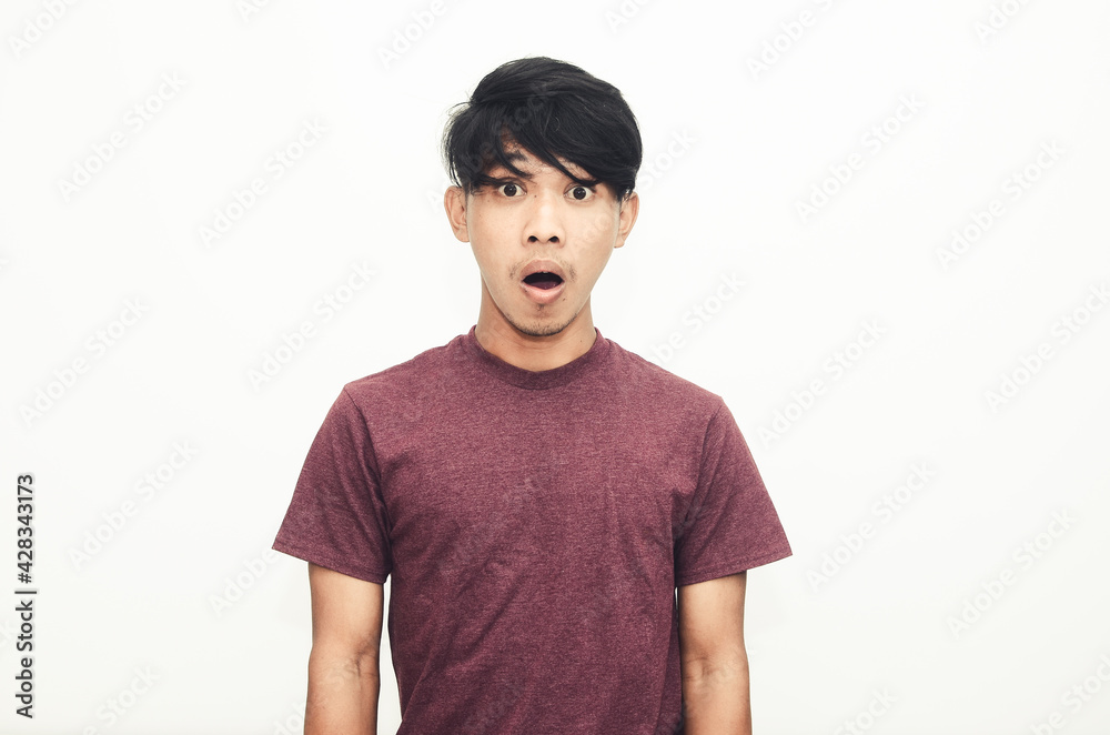 The Asian man smiled in a casual shirt with a shocked expression The Asian man smiled in a casual shirt with a shocked expression