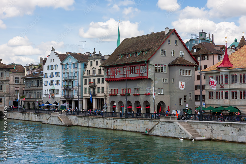 Houses with tiled roofs on the banks of the Limmat River. Zurich, Switzerland