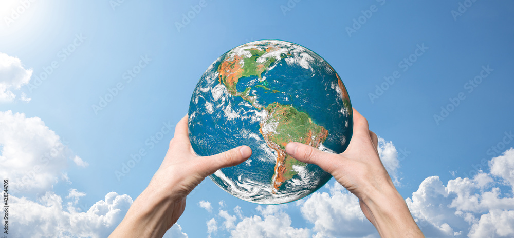 Hands holding a planet, earth on a background of nature blue sky with beautiful white clouds and sunlight.Sustain earth concept. Elements of this image furnished by NASA Hands holding a planet, earth on a background of nature blue sky with beautiful white clouds and sunlight.Sustain earth concept. Elements of this image furnished by NASA