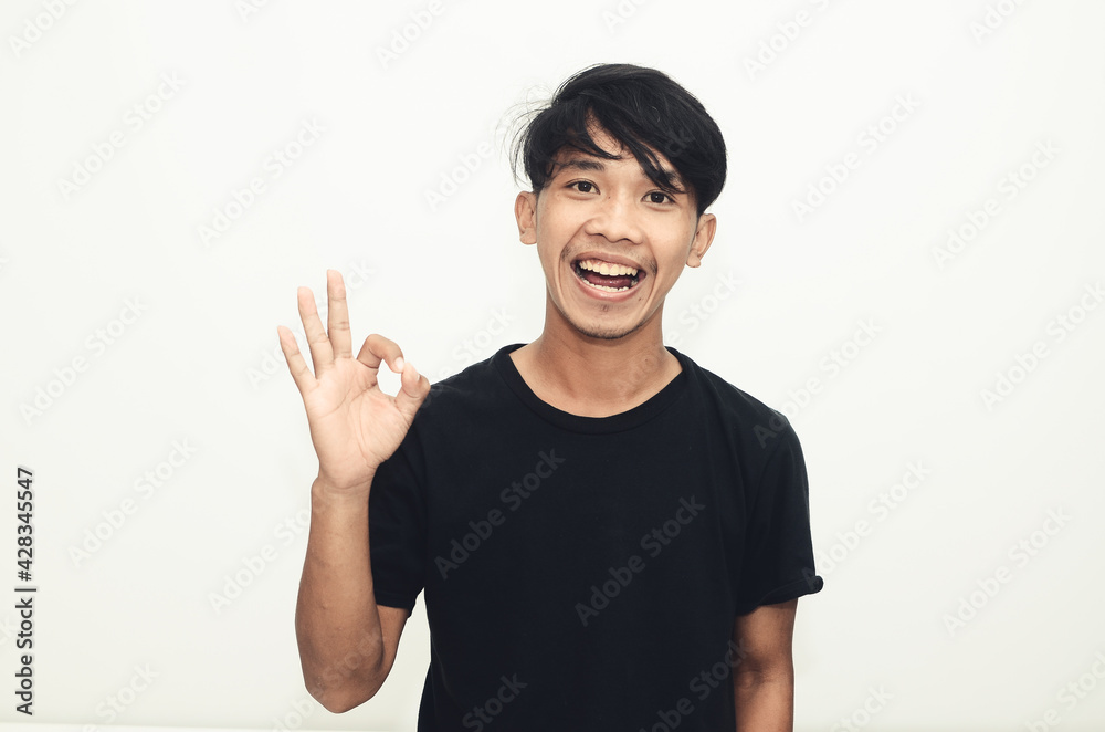 Asian men wear casual black shirts with okay gesture Asian men wear casual black shirts with okay gesture