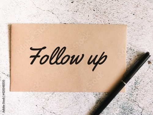 Text follow up written on brown envelope.Business concept.