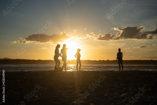 Silhouette of Family Playing on the Beach at Sunset
