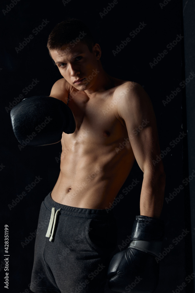 guy with boxing gloves pumped up torso bodybuilder width athlete