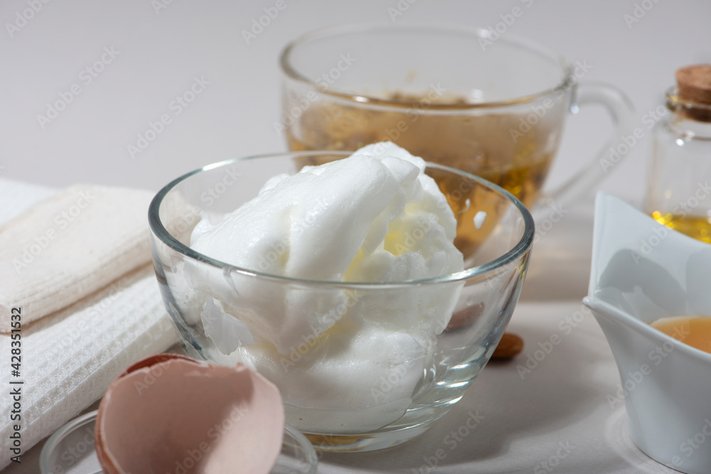 Egg White Face Mask ingredients. Whipped egg white, almond oil, honey, chamomile tea. Homemade cosmetic. Egg White Face Mask ingredients. Whipped egg white, almond oil, honey, chamomile tea. Homemade cosmetic.