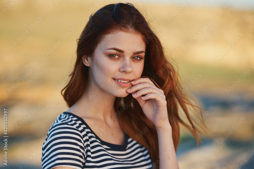 happy red-haired woman outdoors in the mountains smile model hairstyle happy red-haired woman outdoors in the mountains smile model hairstyle
