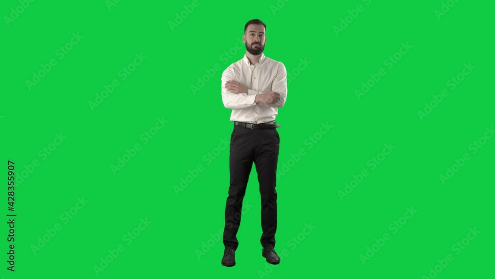 Successful confident business man with hands in pockets crossing arms. Full length on green screen chroma key background. Successful confident business man with hands in pockets crossing arms. Full length on green screen chroma key background.