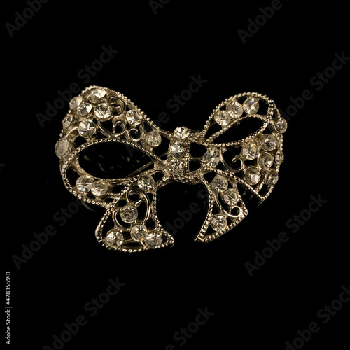 gold jewelry in the form of a bow with white crystals. vintage brooch in the form of a bow