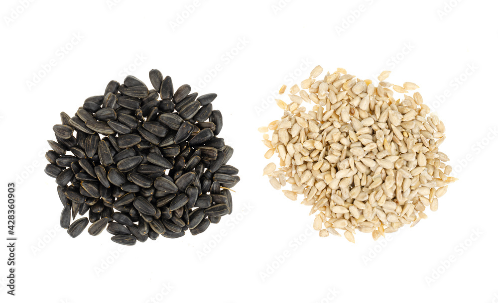 Peeled and in black shell sunflower seeds are frozen in air on white background. Peeled and in black shell sunflower seeds are frozen in air on white background.